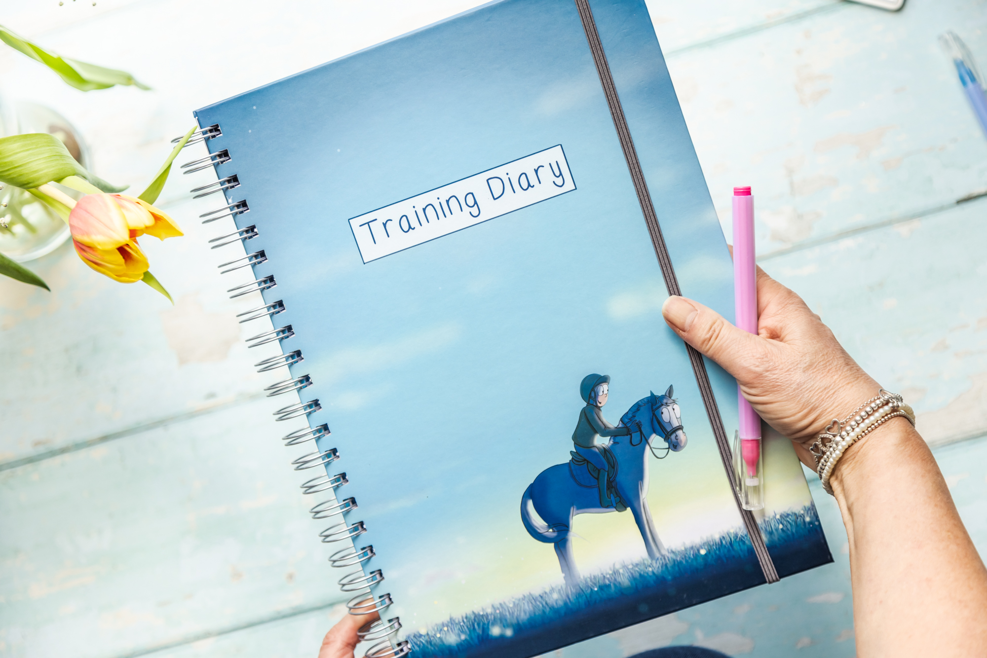 Training diary by Emily Cole being held in a hand