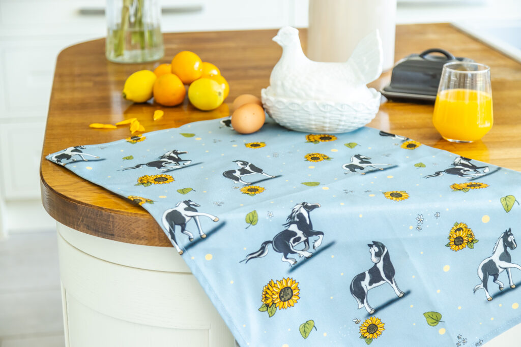 Beautiful blue cotton tea towel decorated by a Piebald Horse Pattern which includes, a Gypsy Vanner Cob, Hogged Cob and a Piebald Sports Horse.